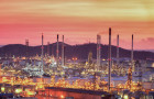 Oil refinery with tube and oil tank along twilight sky